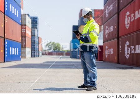 Foreman or worker work at Container cargo site check up goods in container. Foreman or worker work at Container cargo site check up goods in container. 136339198