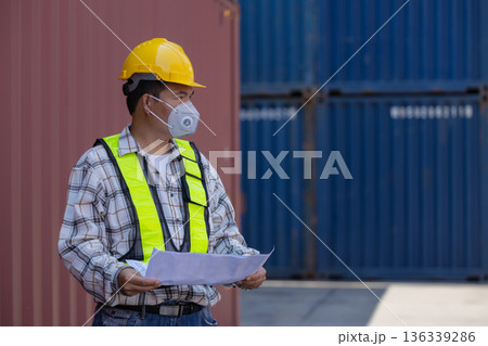 Foreman or worker work at Container cargo site check up goods in container. Foreman or worker work at Container cargo site check up goods in container. 136339286