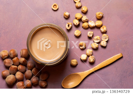 Aromatic Hazelnut Cream In A Jar With Scattered Nuts And Spoon 136340729