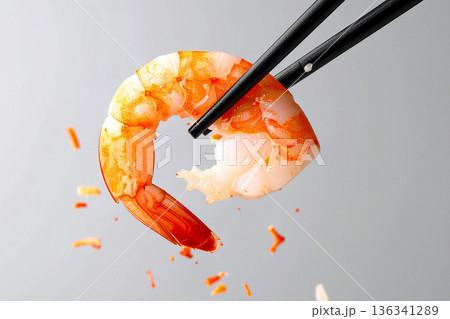 a shrimp tail held with chopsticks 136341289