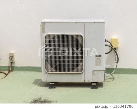 Air conditioner compressor installed in old building.  136341790