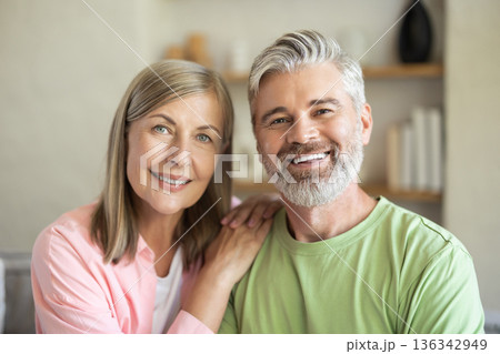 Happy couple looking at camera during home leisure Happy couple looking at camera during home leisure 136342949