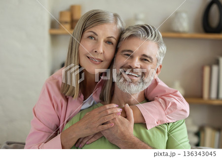 Mature couple embracing on sofa relaxing and enjoying moment of calm 136343045