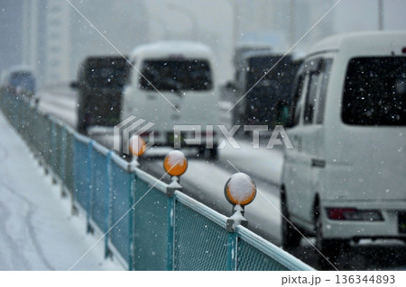 渋滞する車に積もる雪とオレンジのデリネーター 新荒川大橋 渋滞する車に積もる雪とオレンジのデリネーター 新荒川大橋 136344893