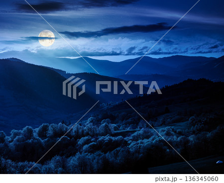 gorgeous countryside in spring at night. beautiful mountain landscape with cloudy sky over the forested rolling hills in full moon light. mysterious scenery with atmospheric weather in highland vista gorgeous countryside in spring at night. beautiful mountain landscape with cloudy sky over the forested rolling hills in full moon light. mysterious scenery with atmospheric weather in highland vista 136345060