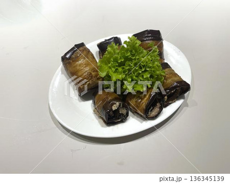 a plate of badrijane with a salad on it 136345139