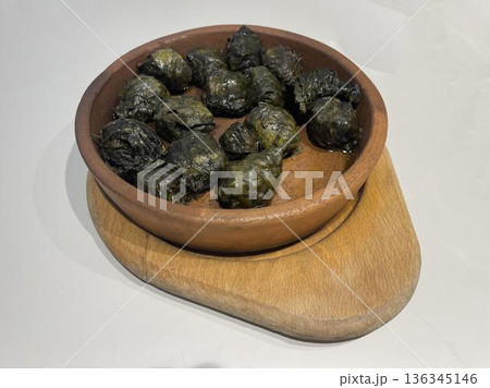 a bowl of dolma on a wooden  board 136345146