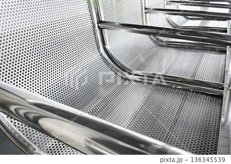 perforated stainless steel waiting bench in public transit station close up 136345539