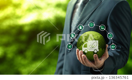 Businessman holding a mossy green globe with sustainability icons, representing eco-friendly logistics, carbon footprint reduction, and green transportation in a nature background Businessman holding a mossy green globe with sustainability icons, representing eco-friendly logistics, carbon footprint reduction, and green transportation in a nature background 136345761