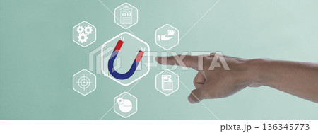 A hand points to a horseshoe magnet icon representing lead generation and customer attraction, surrounded by business strategy icons for marketing and sales growth concepts 136345773