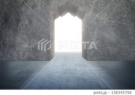 A conceptual architectural image featuring a stone wall with a decorative archway opening into a brilliant white light, symbolizing hope, a new path, or an exit 136345788