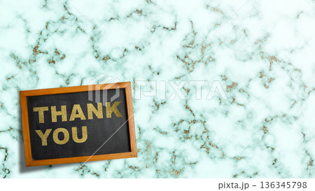 Elegant gold glitter Thank You message on a small blackboard, set against a stylish mint green and gold marble texture with ample copy space for custom text Elegant gold glitter Thank You message on a small blackboard, set against a stylish mint green and gold marble texture with ample copy space for custom text 136345798