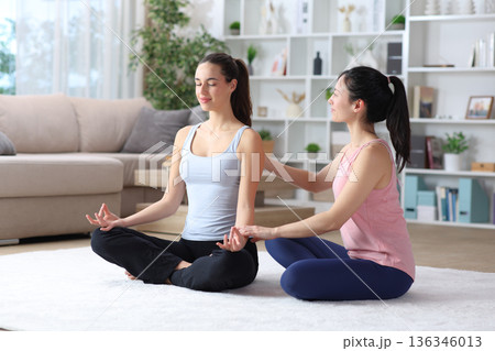 Private teacher teaching yoga at home 136346013