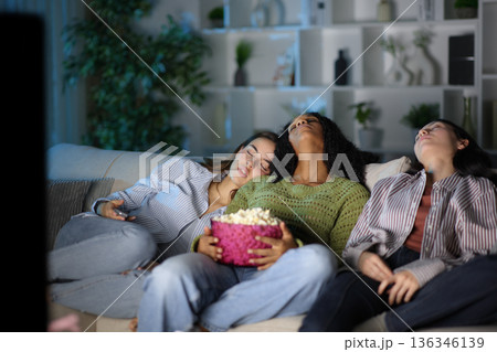 Diverse friends sleeping watching tv in the night Diverse friends sleeping watching tv in the night 136346139