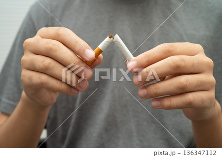 Man holding cigarette, no smoking. 136347112