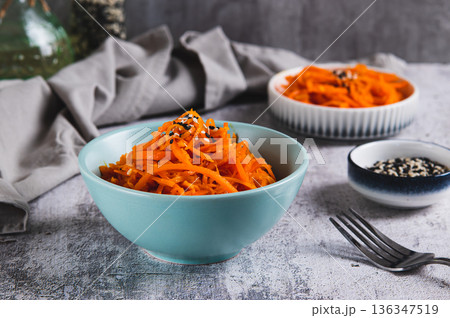 Korean carrots with sesame seeds in a bowl on the table 136347519