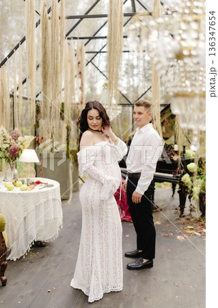 Pregnant woman and man celebrating maternity in greenhouse 136347654