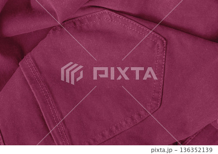 Close-up of red pants pocket showing textile texture and stitch detail. Fashion color trend, fabric texture, textile material, clothing design, color of year, magenta background 136352139