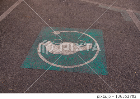 Electric Vehicle Parking Sign Painted on Asphalt 136352702