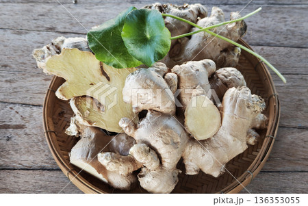 Ginger and gotu kola leaves in a basket. 136353055