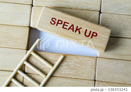 SPEAK UP text on wooden blocks highlighting employee voice and transparent workplace communication. 136353241