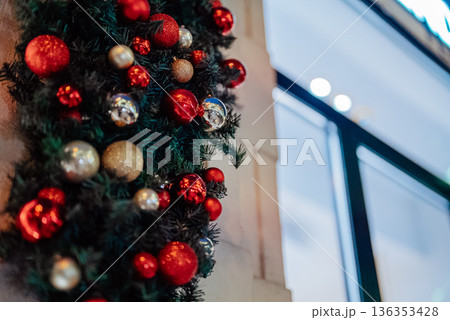 Beautifully decorated Christmas building with pine branches and glossy baubles 136353428