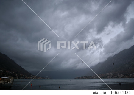 Stormy Coastal Bay With Mountains and Overcast Sky Stormy Coastal Bay With Mountains and Overcast Sky 136354380