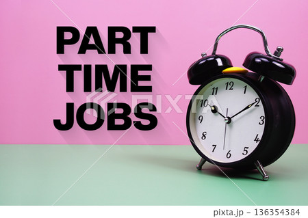 Black alarm clock on a pastel green and pink background with the text "Part Time Job" 136354384