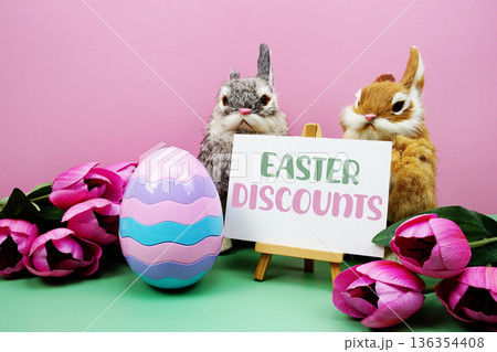 Easter Discounts text with easter elements decoration on pink and green background Easter Discounts text with easter elements decoration on pink and green background 136354408