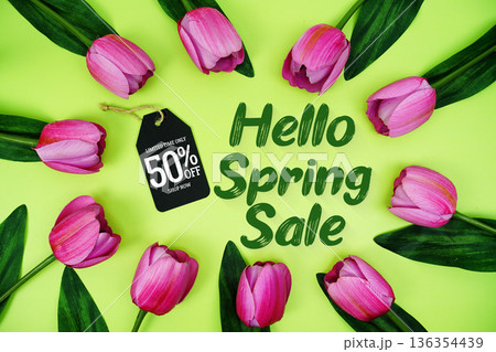 Hello Spring Sale and Price tag 50% off with tulip flowers on green background Hello Spring Sale and Price tag 50% off with tulip flowers on green background 136354439