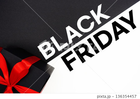 Black Friday text with gift box present on black and white background 136354457