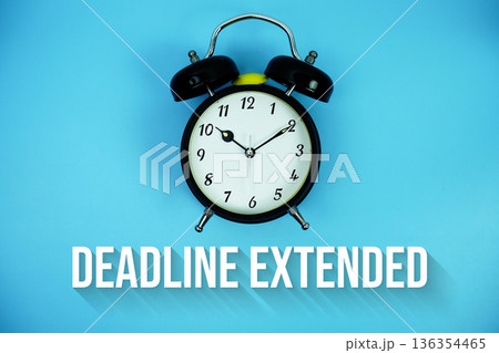 Deadline Extended text and alarm clock on blue background 136354465