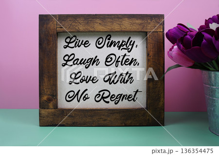 Live Simply, Laugh Often, Love With No Regret message with tulip flower in metal vase Live Simply, Laugh Often, Love With No Regret message with tulip flower in metal vase 136354475
