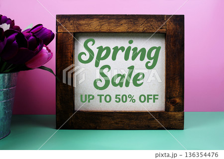 Spring Sale up to 50% off message with tulip flower in metal vase Spring Sale up to 50% off message with tulip flower in metal vase 136354476