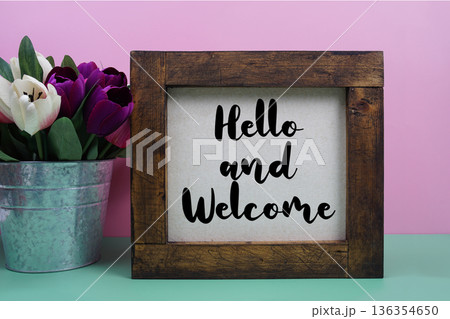 Hello and Welcome message with tulip flower in metal vase Hello and Welcome message with tulip flower in metal vase 136354650