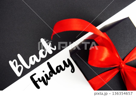 Black Friday text with gift box present on black and white background Black Friday text with gift box present on black and white background 136354657