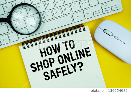 Notepad with the text "How To Shop Online Safely?" and white keyboard, wireless mouse, magnifying glass on yellow background Notepad with the text "How To Shop Online Safely?" and white keyboard, wireless mouse, magnifying glass on yellow background 136354683