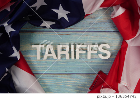Tariffs alaphbet letters with usa flag on wooden background Tariffs alaphbet letters with usa flag on wooden background 136354745