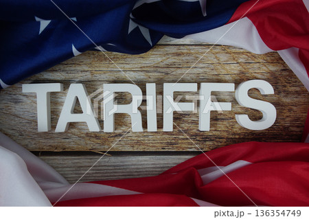 Tariffs alphabet letters with usa flag on wooden background Tariffs alphabet letters with usa flag on wooden background 136354749