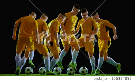 Football player dribbling ball in coordinated footwork sequence. Football player dribbling ball in coordinated footwork sequence. 136354853