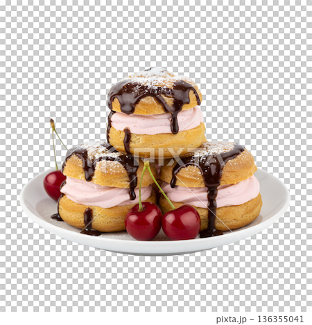 Delicious french cream puffs profiteroles topped with chocolate drizzle and fresh cherries, isolated. Perfect for bakery treats and desserts 136355041