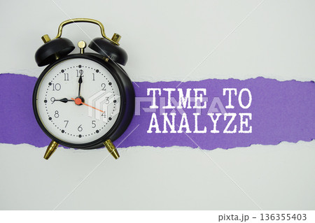 Time To Analyze text on purple with white paper torn ripped of horizontal and alarm clock Time To Analyze text on purple with white paper torn ripped of horizontal and alarm clock 136355403