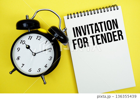Invitation For Tender text with alarm clock flat lay on yellow background Invitation For Tender text with alarm clock flat lay on yellow background 136355439