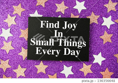 "Find Joy In small Things Every Day" quotes on paper card with purple glitter background with pink and white stars "Find Joy In small Things Every Day" quotes on paper card with purple glitter background with pink and white stars 136356648