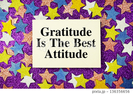 "Gratitude is the Best Attitude" quotes on paper card with purple background with colorful glitter stars 136356656