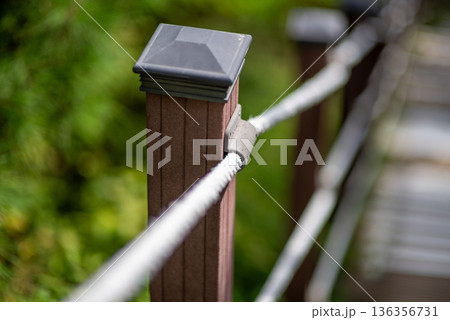 Rope Handrail on Wooden Railing Post with Bokeh Background 136356731