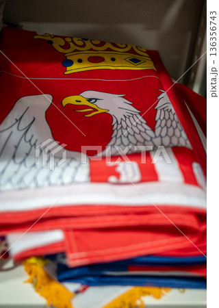 Folded polish Serbian flag with white eagle coat of arms Folded polish Serbian flag with white eagle coat of arms 136356743
