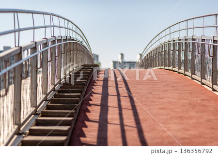 Empty pedestrian overpass with stairs and red walkway 136356792