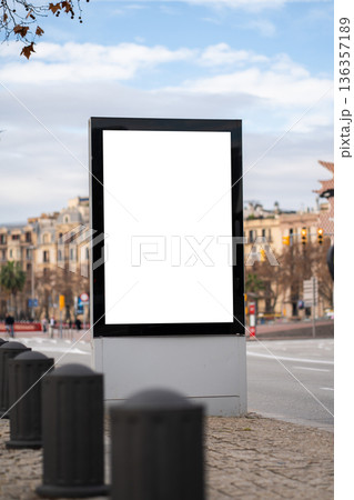 Vertical blank street advertising billboard mockup on a city sidewalk, offering copy space for urban marketing campaigns and public information displays 136357189