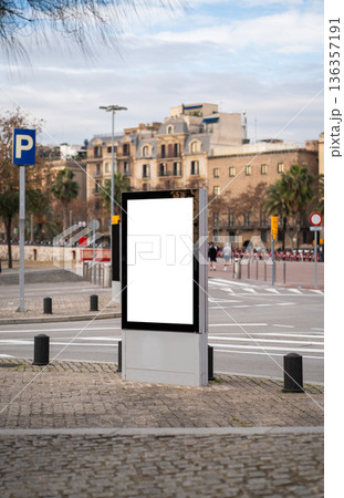Blank vertical advertising billboard standing in a city street, ready for custom message insertion, offering prime outdoor advertising space on urban background Blank vertical advertising billboard standing in a city street, ready for custom message insertion, offering prime outdoor advertising space on urban background 136357191